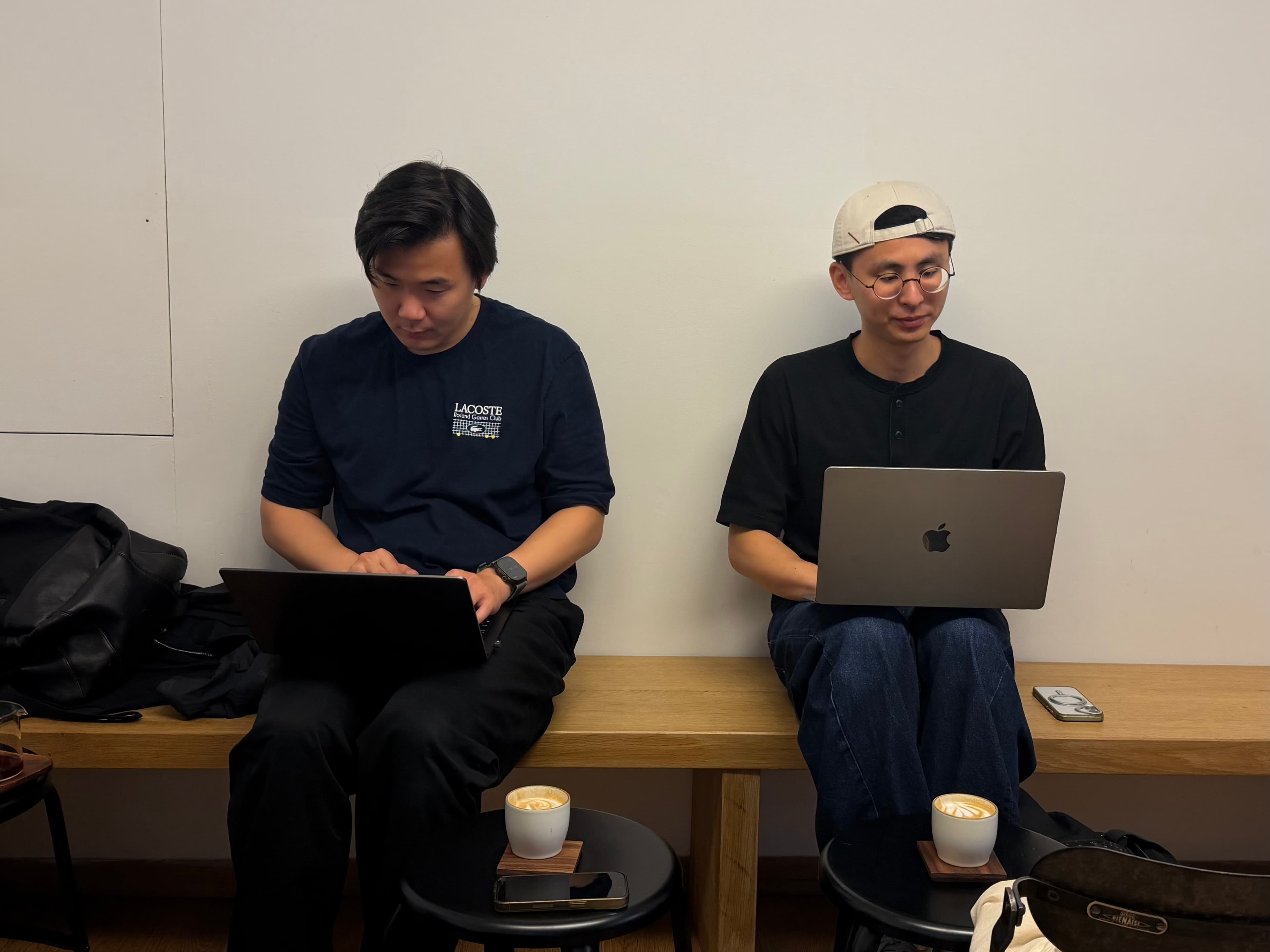 Wei and Lichin working side by side on their laptops